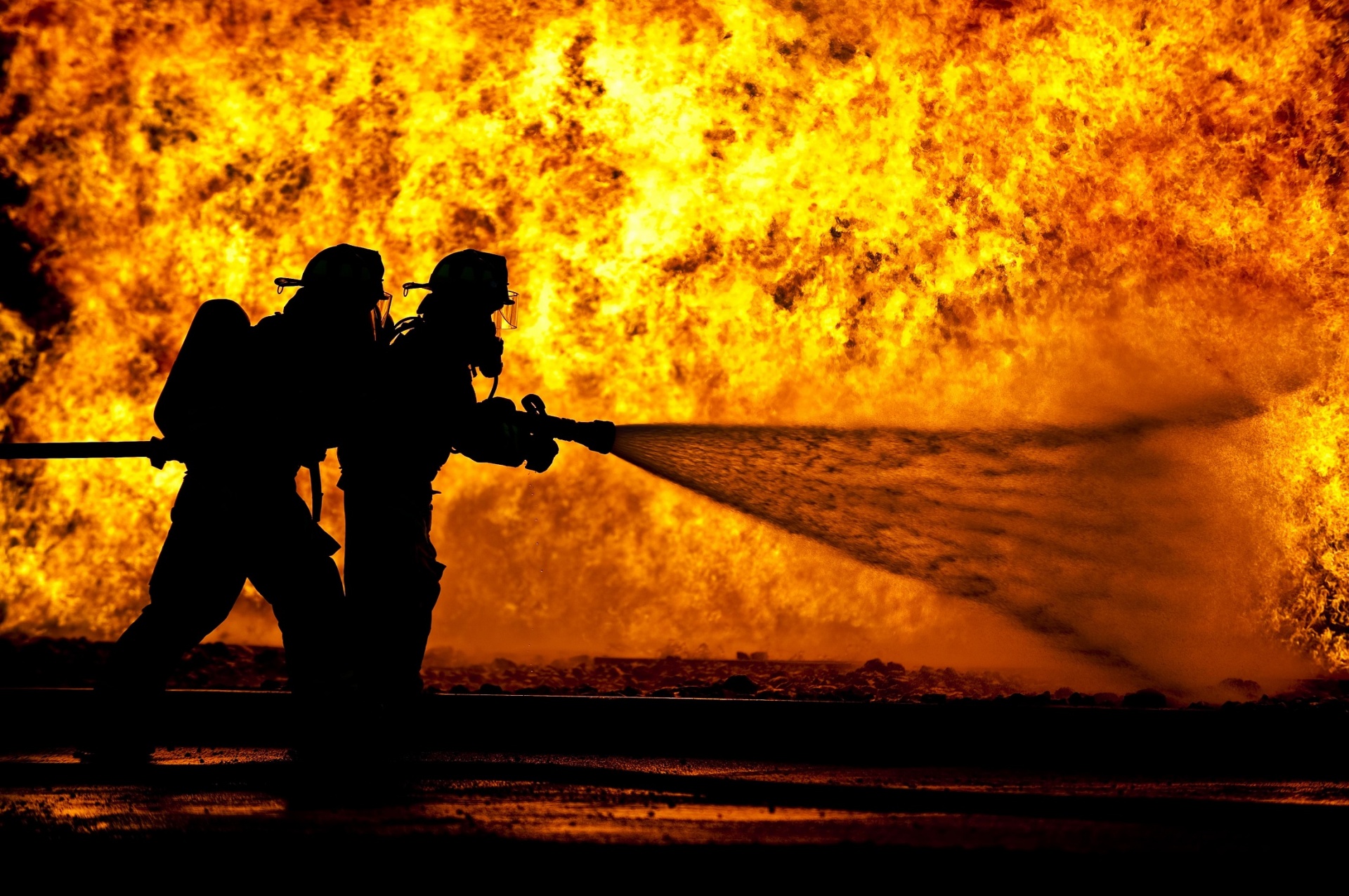 Two firefighters battle active fire