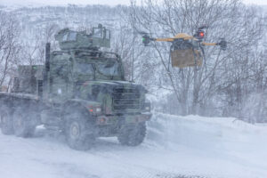 Marines use a tactical resupply unmanned aircraft system in the winter snow